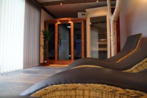 a bedroom with a bed and a glass door at Alpenchalet Gosau in Gosau