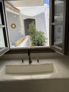 a kitchen sink in front of a window at La Maison de Bella in Lefkes +56 photos