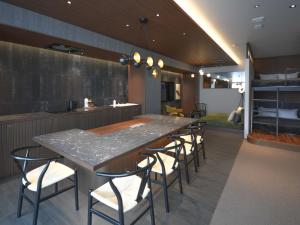 a kitchen with a large table and some chairs at illi Gran Azabujuban in Tokyo +55 photos