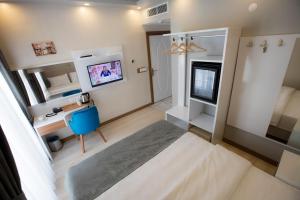 a bedroom with a bed and a tv in it at Royal İnci Hotel in Istanbul