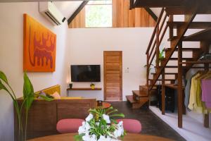 a living room with a staircase and a television at THE LOFT - Super Central General Luna in General Luna