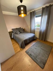 a bedroom with a bed and a window at appartement tout confort dans villa avec piscine in Cébazat +20 photos