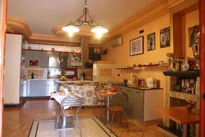 a large kitchen with a table and chairs in it at Villa Manno in Barcellona-Pozzo di Gotto