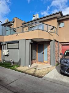 a house with a car parked in front of it at Sredna Home in Braybrook
