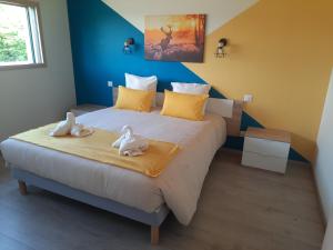a bedroom with a large bed with two swans on it at Le coin de paradis du Haut-Jura in Fort-du-Plasne