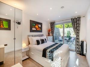 a bedroom with a bed and a balcony at Little Heron - Uk40928 in Holdenhurst