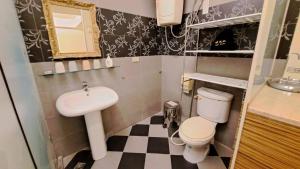 a small bathroom with a sink and a toilet at 日月潭水社海民宿 in Yuchi +19 photos