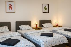 a room with four beds and two lamps at Apartmán Strážske s balkónom in Michalovce
