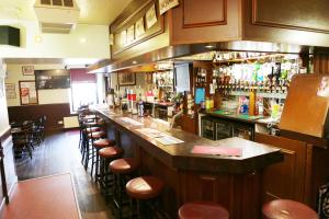 a bar in a restaurant with a lot of bar stools at The Station Hotel in Portsoy