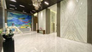 a lobby with a large painting on the wall at REOTEL at CITRAPLAZA NAGOYA BATAM in Jodoh +4 photos