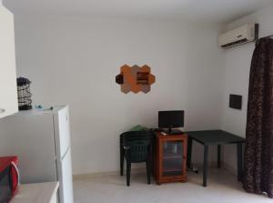 a kitchen with a small table and a refrigerator at Sunshine calabria in Pizzo