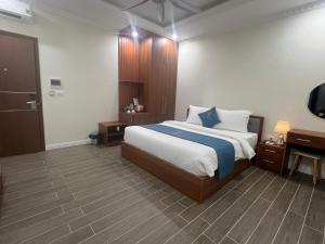 a bedroom with a bed and a tv in it at Royal Louis Hotel in Hanoi +77 photos