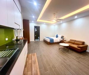 a living room with a bed and a couch at Royal Louis Hotel in Hanoi