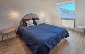 a bedroom with a large bed with blue sheets and a window at Beautiful Home In Pordic With Wifi in Pordic +39 photos