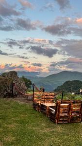 a pile of logs sitting on top of a field at MOUNTAIN HOUSE In ROSHKA in Roshka