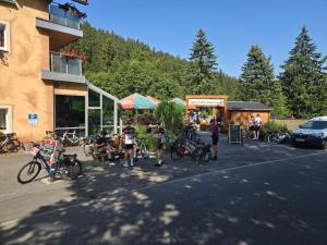 a group of people sitting in a parking lot with bikes at Hotel Ladenmühle in Kurort Altenberg