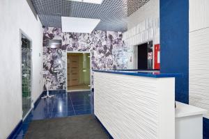 a kitchen with a blue and white wall at Medical Hotel & SPA Tyumen in Tyumen