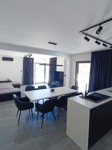 a kitchen and dining room with a table and chairs at Holiday House "M" Omiš - Newly renovated house with swimming pool, 3 rooms, gym, large terrace with amazing view on town and 6 parkplaces in Omiš