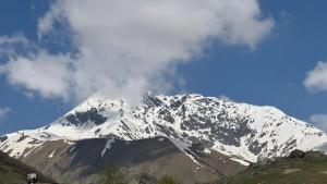 a snow covered mountain with a blue sky at MOUNTAIN HOUSE In ROSHKA in Roshka +9 photos