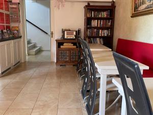 a dining room with a table and a book shelf at Hotel Esperides in Kardamyli
