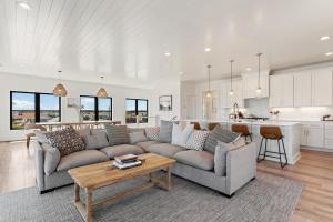 a living room with a couch and a kitchen at 4007 - Bellahaven in Kitty Hawk