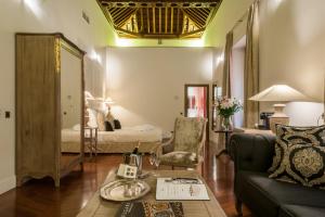un soggiorno con divano e letto di Palacio Pinello a Siviglia