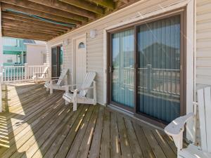 a porch with rocking chairs on a house at 4070 - Sea Spray in Kitty Hawk