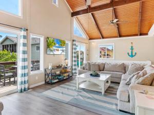 a living room with a couch and a table at 1662 - Dune Our Thing in Corolla