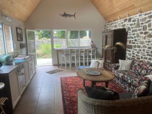 a kitchen and living room with a couch and a table at Le cottage in Crozon +53 photos
