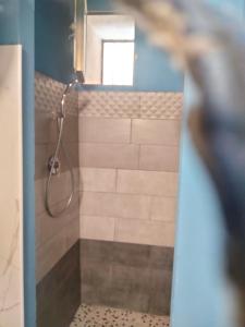 a bathroom with a shower with a glass door at Loft House in Pizzo