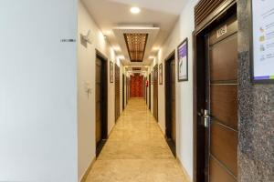 a corridor in a building with a hallway at Treebo Red Coral in Haridwār