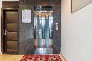 an elevator in a building with a rug in front of it at Treebo Red Coral in Haridwār +24 photos