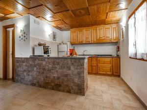 a kitchen with wooden cabinets and a counter top at Casa Vacanze Nikita in Sperlonga