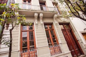 a white building with windows and a balcony at Marcel de Buenos Aires in Buenos Aires