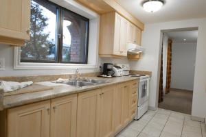 a kitchen with a sink and a window at Motel Du Chevalier in Gatineau