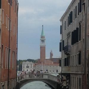 a bridge over a river with a clock tower at Ca dei Libri in Venice