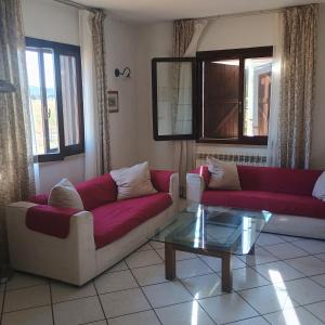 a living room with two couches and a coffee table at Villa Angeli in La Torba