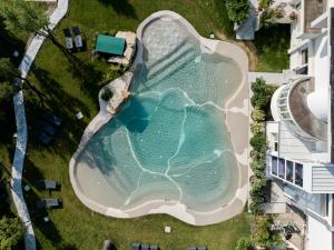 an overhead view of a swimming pool in a building at Hotel Terme Milano in Abano Terme