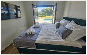 a bed with shoes on it in a bedroom at Gorgeous Home In Sveti Ivan Zelina in Sveti Ivan Zelina