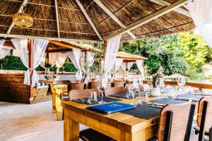 a dining room with a wooden table and chairs at Adriatic Beach Glamping in Orebić