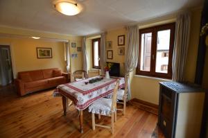 a living room with a table and a couch at Sabrina Fantasia in Campodolcino