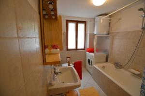 a bathroom with a sink and a toilet and a tub at Sabrina Fantasia in Campodolcino