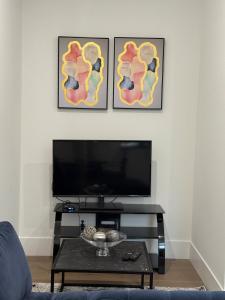 a living room with a tv and a table at Calm & Cozy Private Suite in Surrey