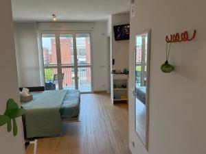 a bedroom with a bed and a room with a window at MarteNik Apartment, vicino San Raffaele e Milano in Vimodrone