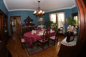 a dining room with a red table and chairs at Bondy House Bed & Breakfast in Amherstburg