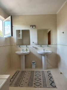 a bathroom with two sinks and a mirror at Family cottage in Bosteri +33 photos