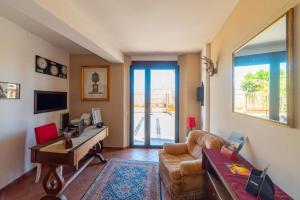 a living room with a couch and a table at Sirami Apartments in Taormina
