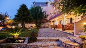 a courtyard of a house with a brick walkway at Christianna Studios in Nikiana