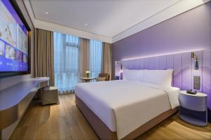 Postelja oz. postelje v sobi nastanitve Shanghai Hongqiao Airport National Exhibition Center Manxin Hotel