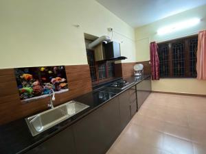 a kitchen with a sink and a counter top at JSP Guest House in Vilinjam